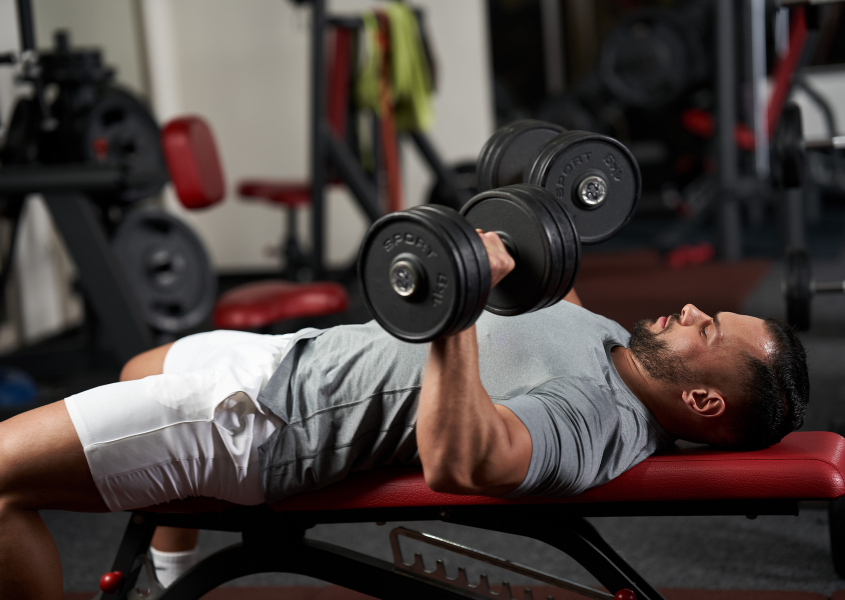 man doing dumbbell bench press