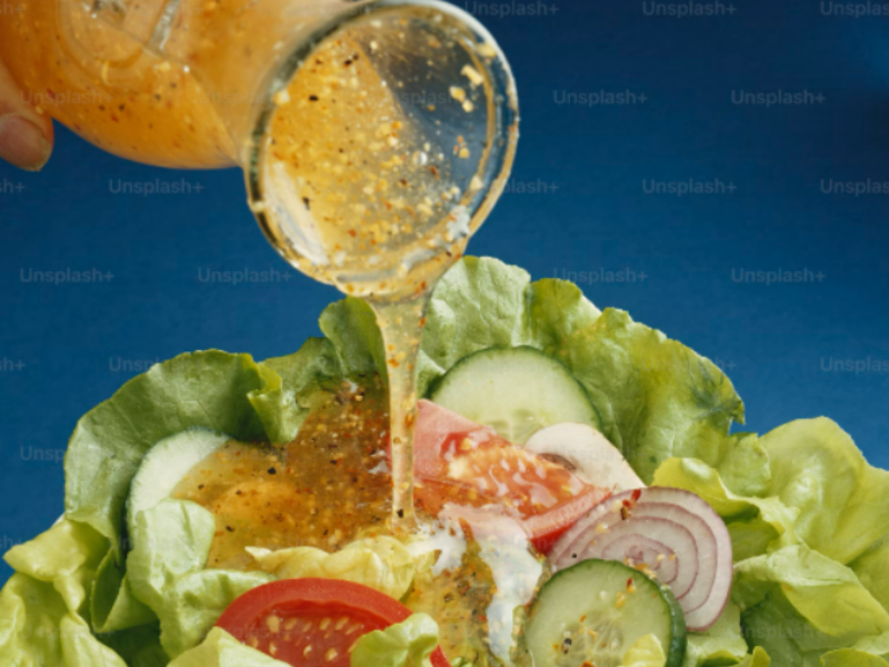 A salad with large amounts of sauce.