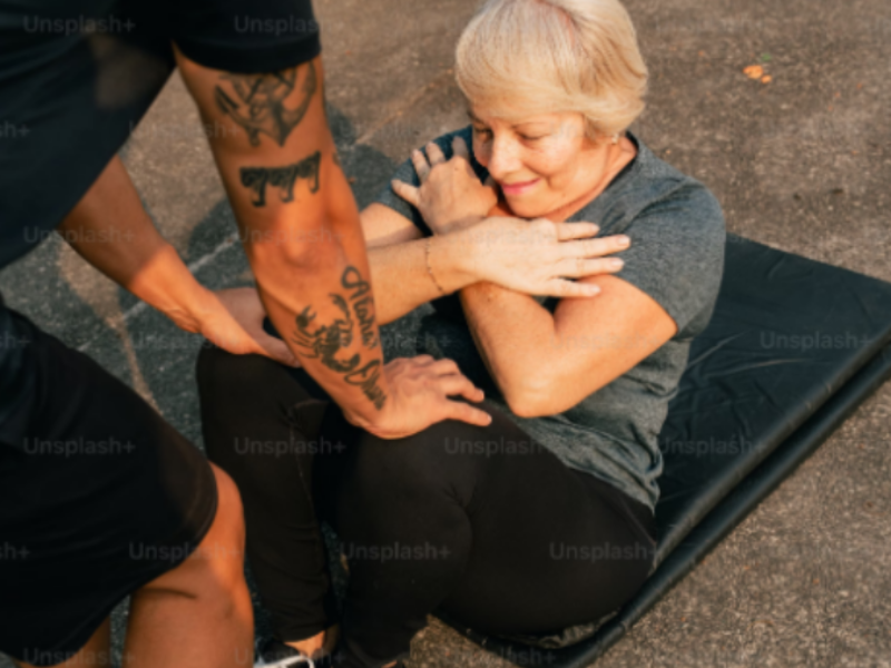 A beginner that requires help to correct her sit up form.