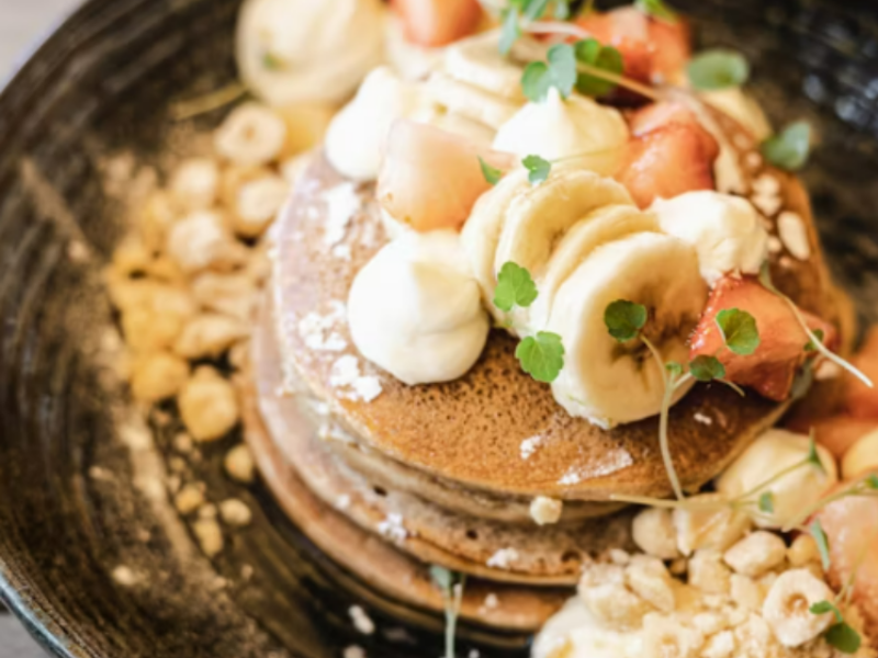 Buckwheat pancakes served on a plate with other toppings.