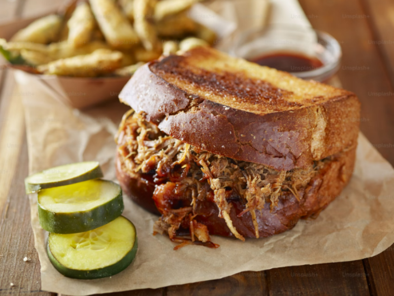 Pulled pork served with bread.