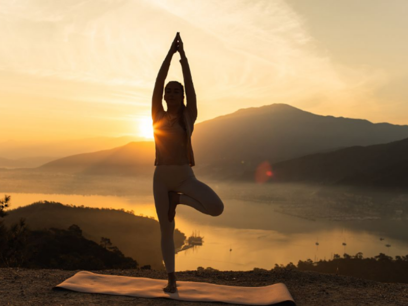 Silhouette of a woman doing daily yoga, a form a physical activity.